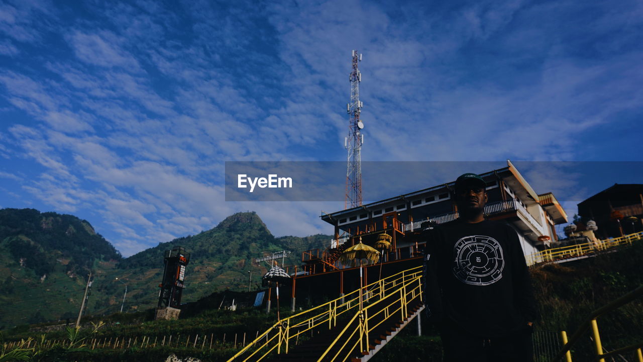 sky, architecture, built structure, evening, nature, landmark, mountain, travel destinations, cloud, travel, building exterior, dusk, outdoors, tourism, landscape, mountain range, building, communication, religion, blue, scenics - nature