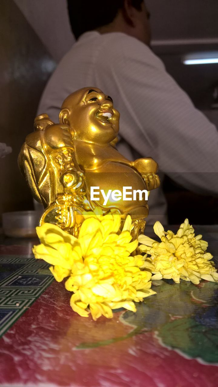 CLOSE-UP OF STATUE OF BUDDHA IN TRADITIONAL