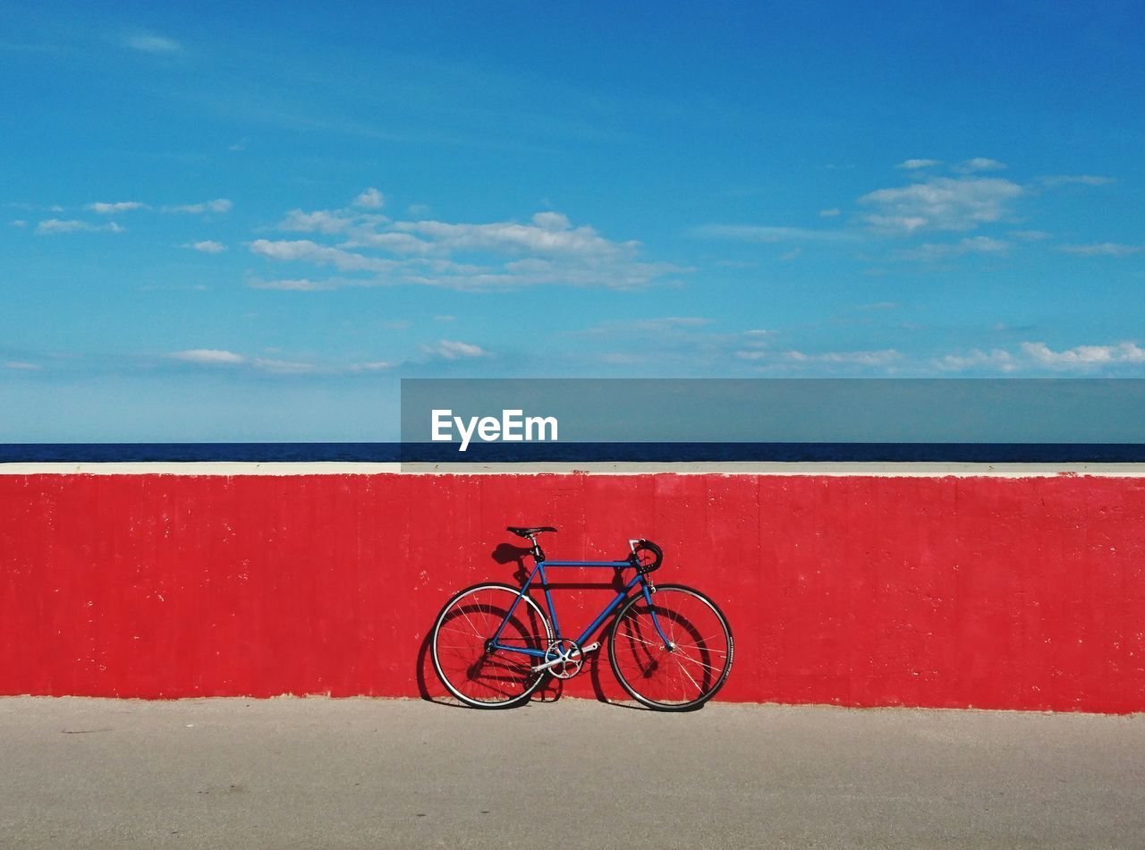 Bicycle against red wall