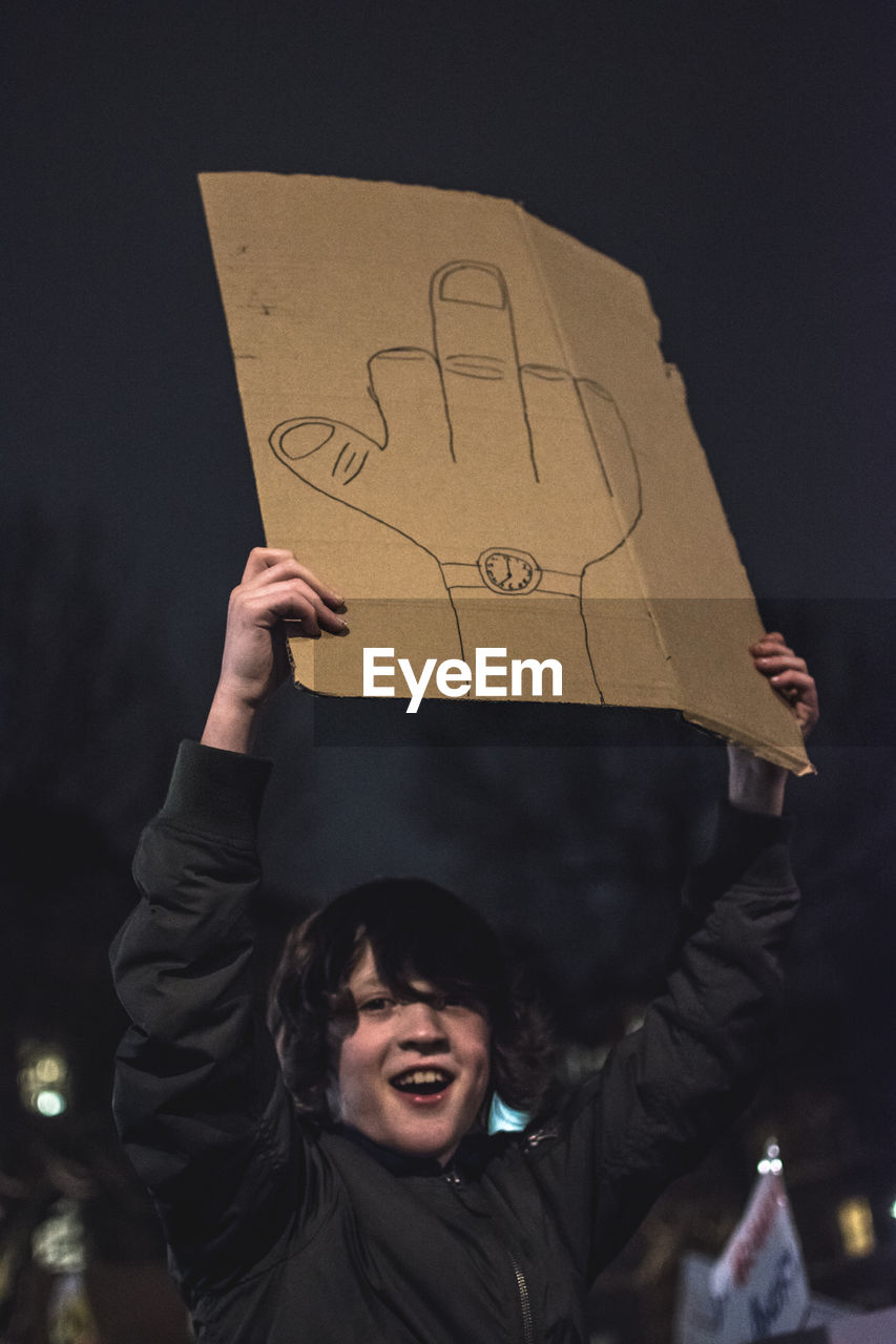 YOUNG MAN WITH TEXT ON PAPER