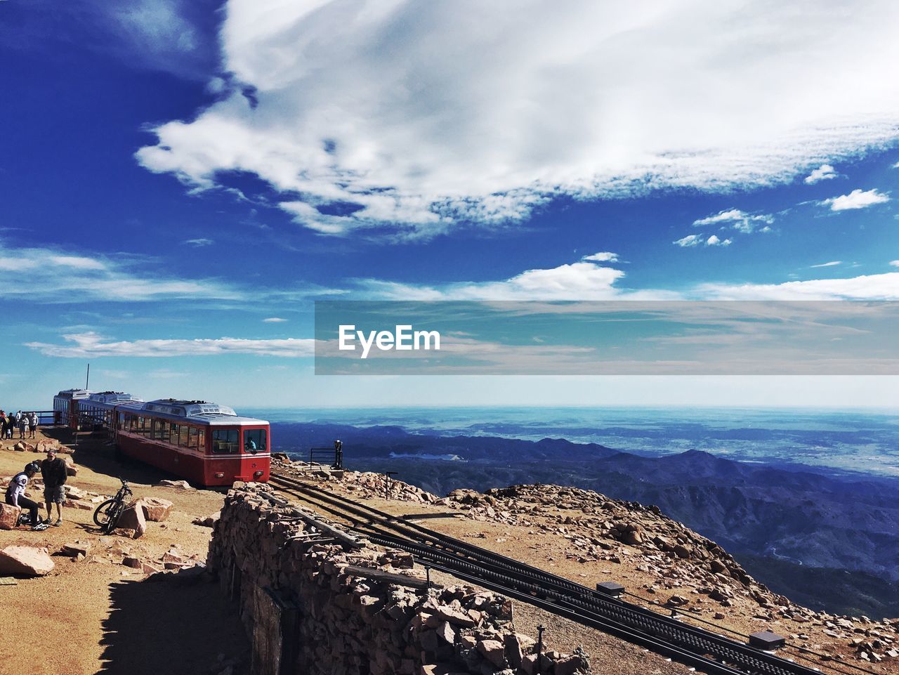 High angle view of train on cliff against mountains