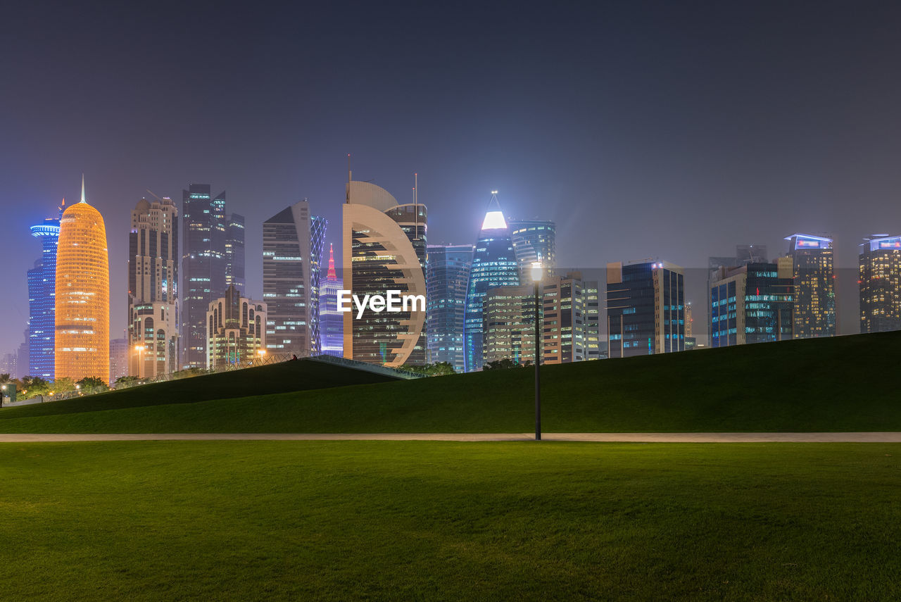 Illuminated buildings in city at night