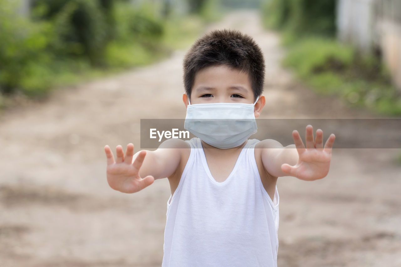 Portrait of cute boy standing outdoors