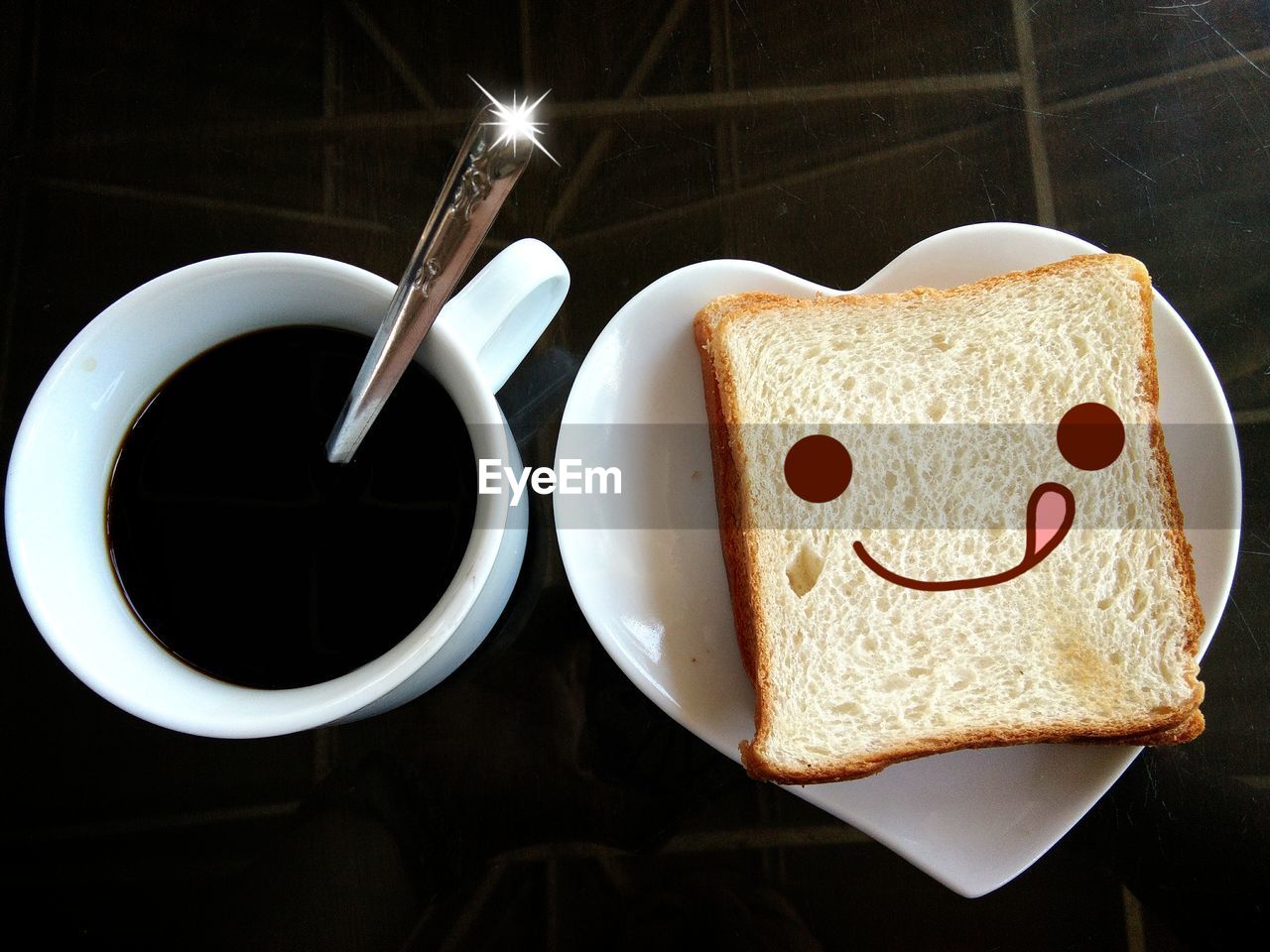 Close-up of coffee cup on table with bread