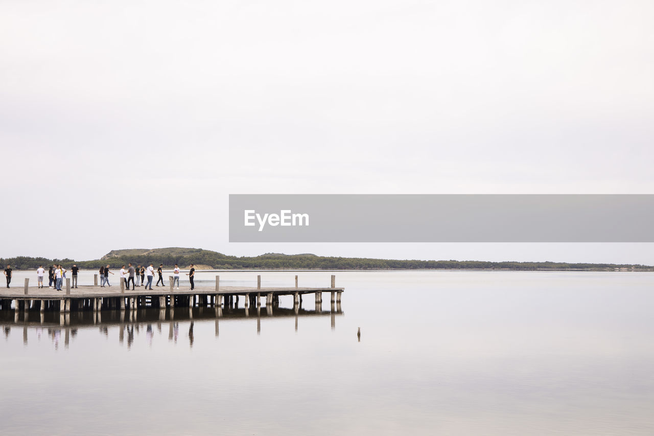 PIER OVER LAKE AGAINST CLEAR SKY