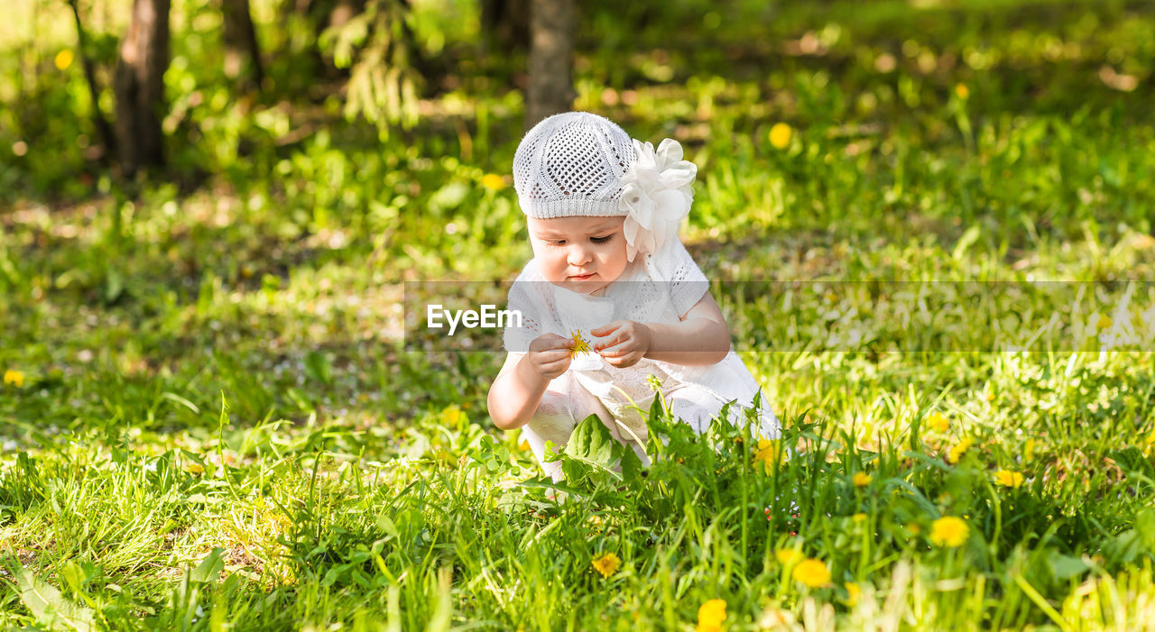 side view of young woman standing on grassy field