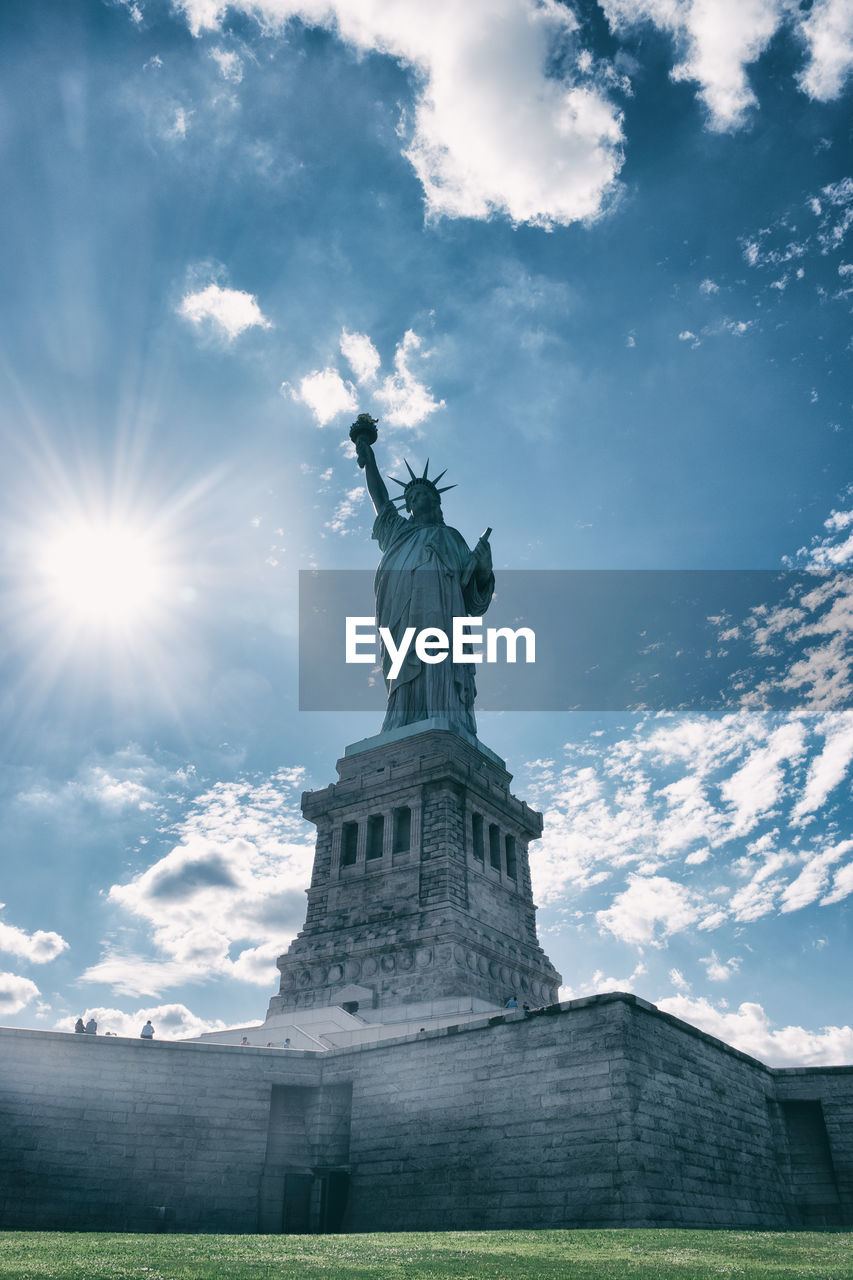 Low angle view of statue of liberty against sky