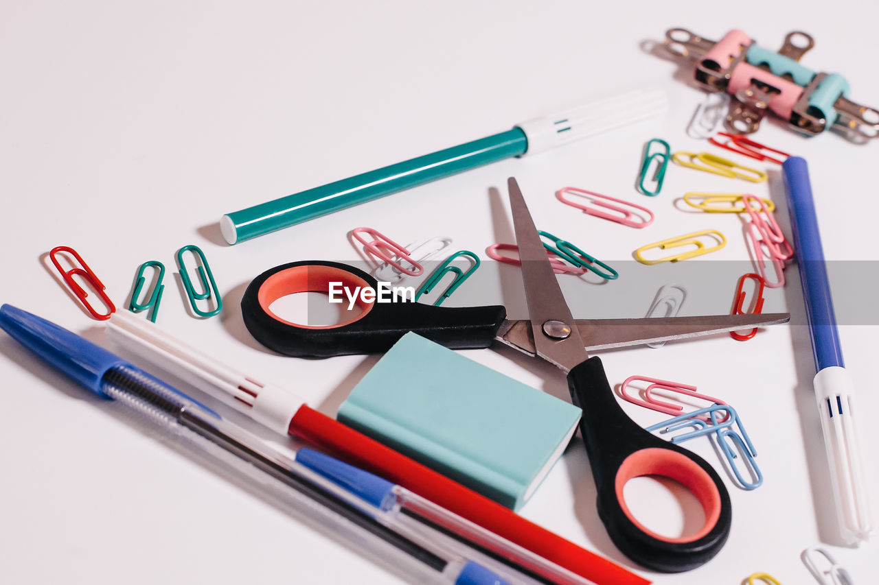 HIGH ANGLE VIEW OF PEN ON TABLE AGAINST WHITE BACKGROUND