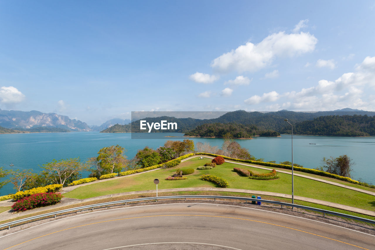 Scenic view of lake by mountains against sky