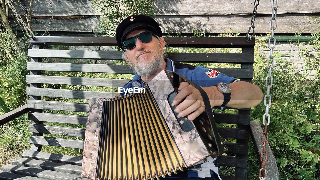 A man playing a diatonic button accordion