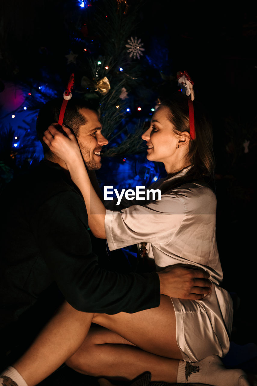 Merry christmas and happy new year. young couple in love celebrating christmas or new year eve at