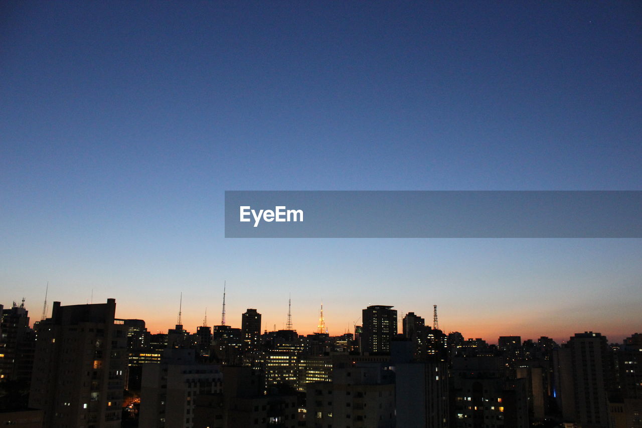 High angle shot of cityscape against clear blue sky