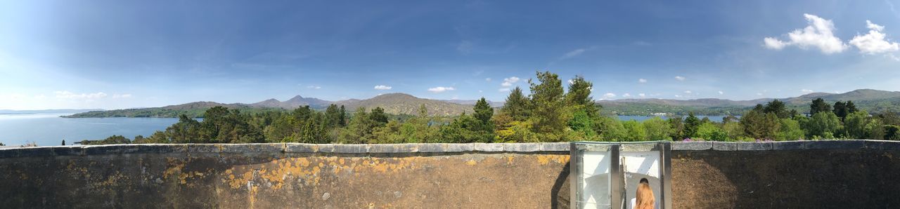 Panoramic view of dam and mountains against sky