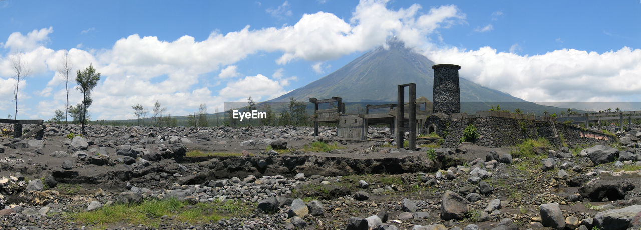 Panoramic shot of old ruins with mayon volcano in background