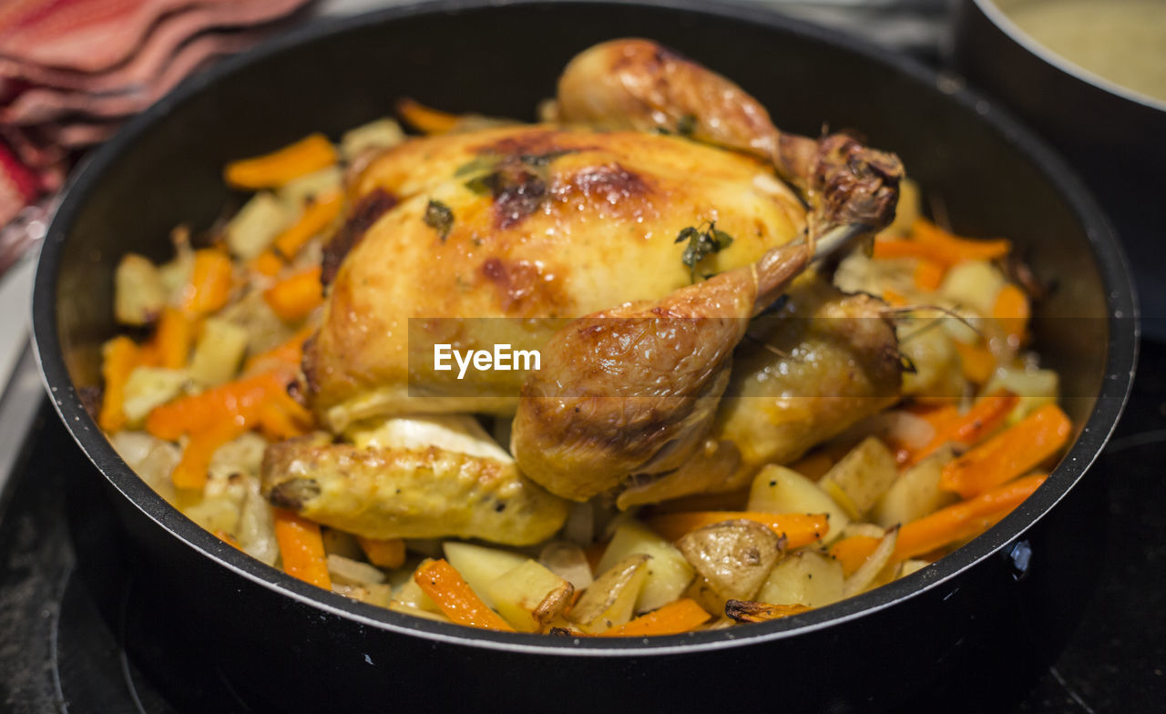 High angle view of meat in container on stove