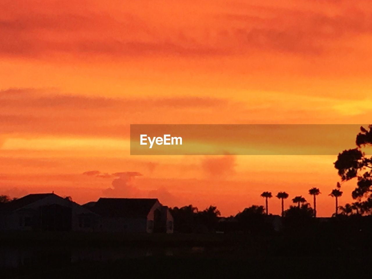 SILHOUETTE OF BUILT STRUCTURES AGAINST DRAMATIC SKY