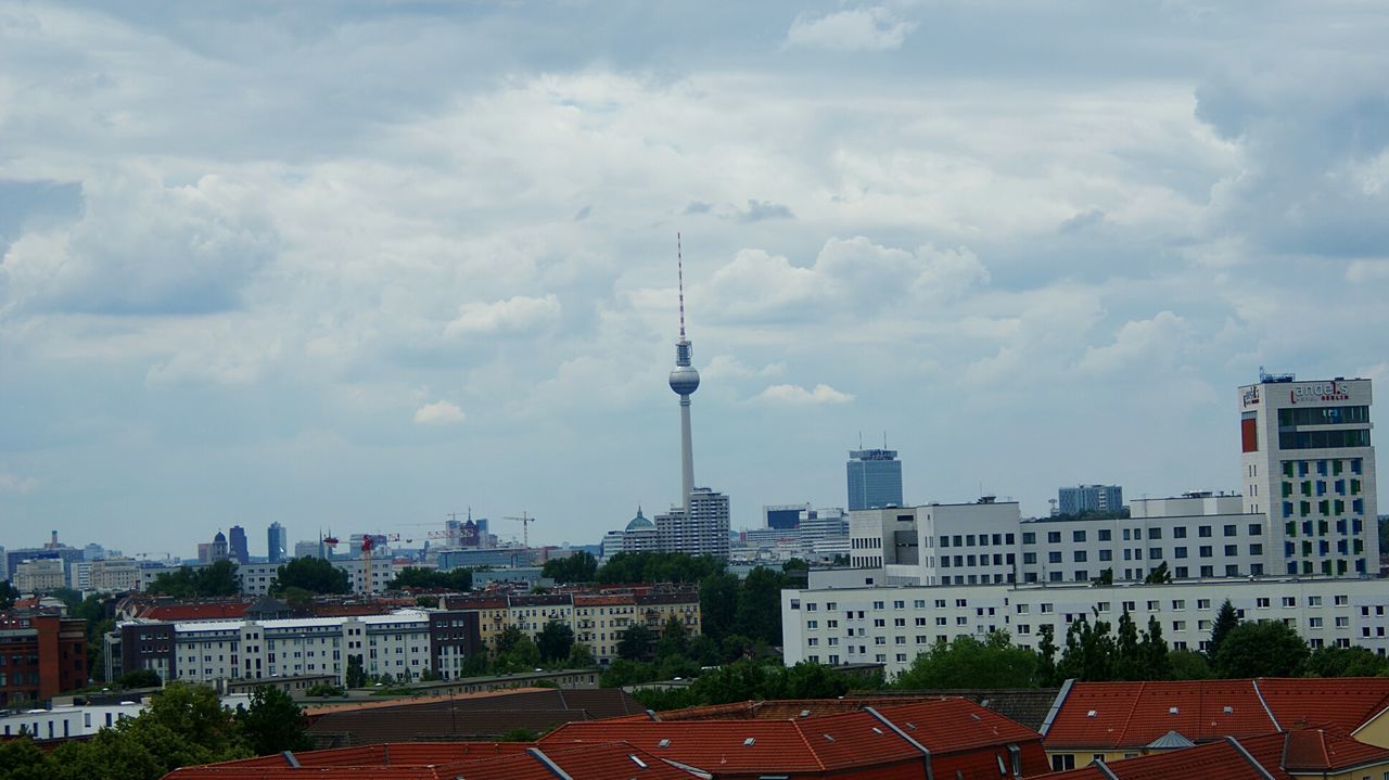 CITY AGAINST CLOUDY SKY