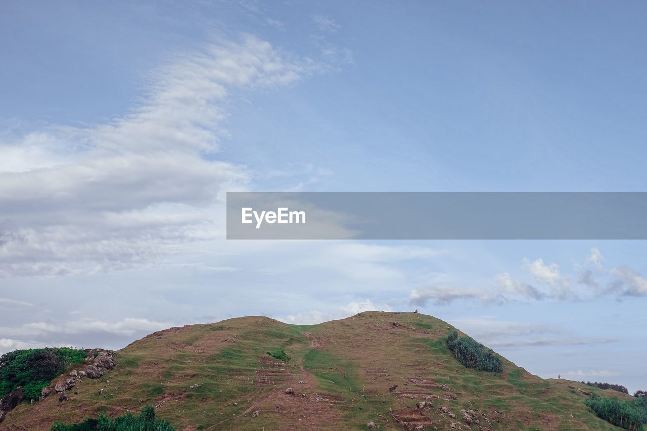 Scenic view of rocky mountains and sea against sky