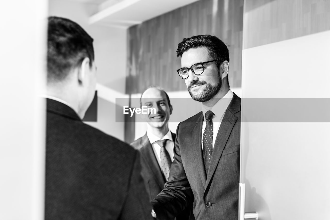 portrait of businessman using mobile phone in office
