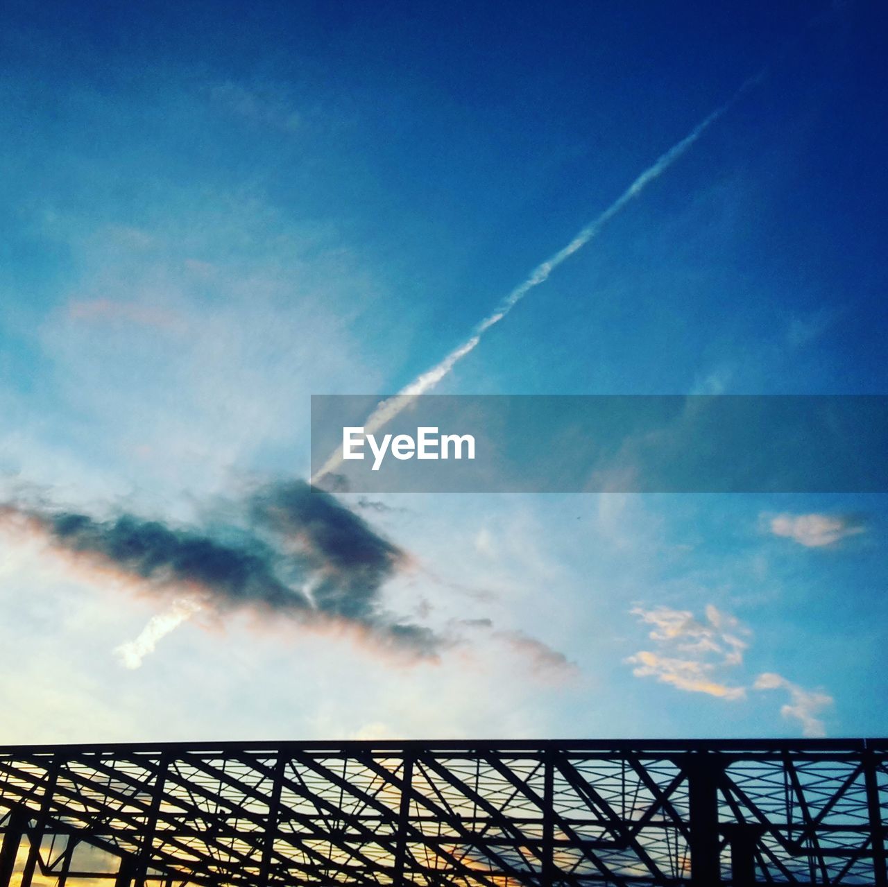 Low angle view of vapor trail against blue sky