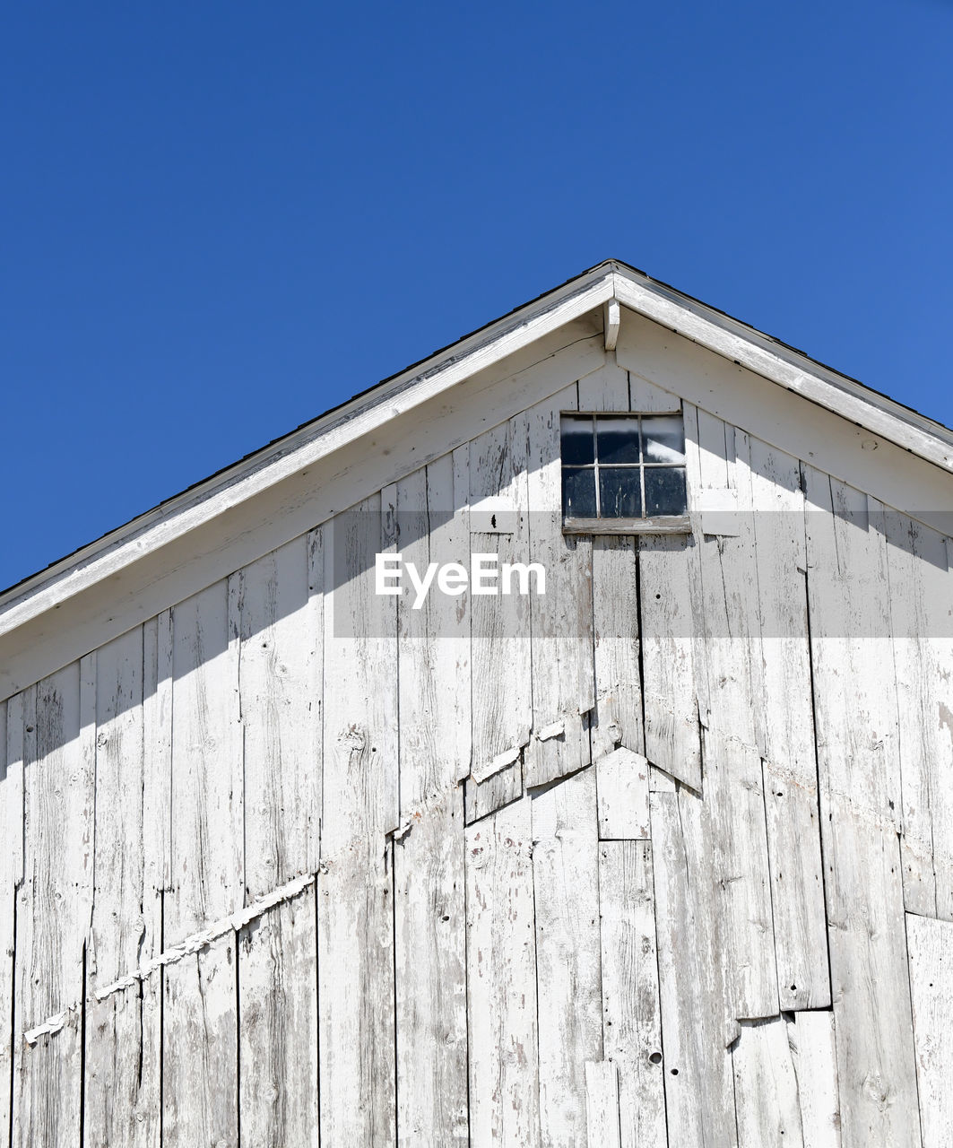 Low angle view of building against clear blue sky