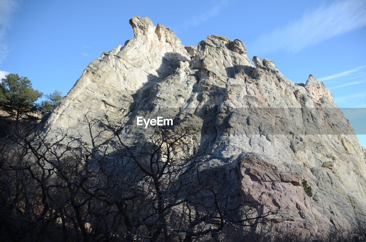 Low angle view of rock formation against sky