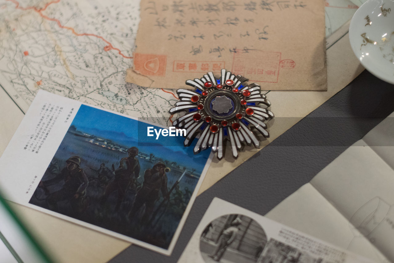 Close-up of medals and photograph on world map