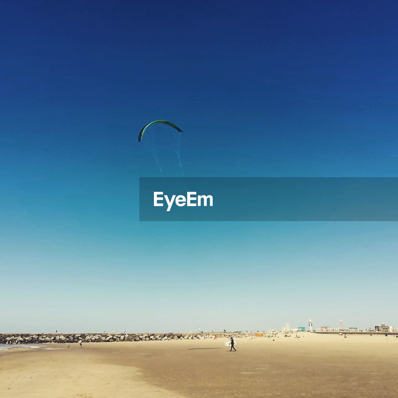 PERSON PARAGLIDING AGAINST CLEAR BLUE SKY