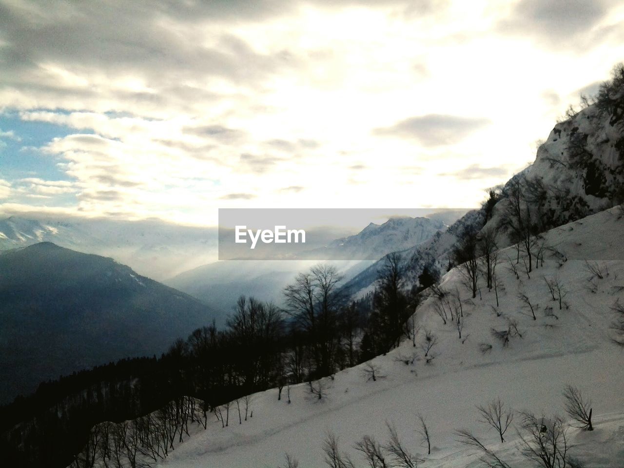 Scenic view of snow covered mountains against sky