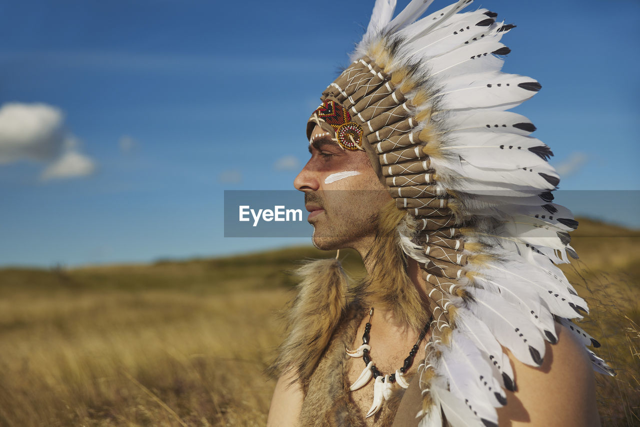 A man in traditional native american clothing in the steppe