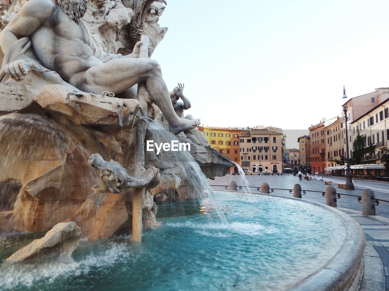 VIEW OF FOUNTAIN IN CITY AGAINST SKY