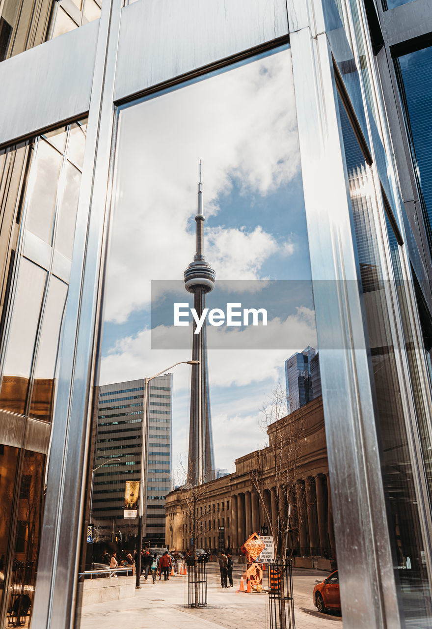 Reflection of cn tower in a window of a building in toronto, canada.