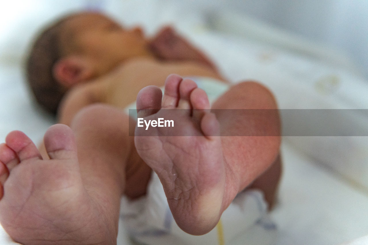 Close-up of baby sleeping on bed