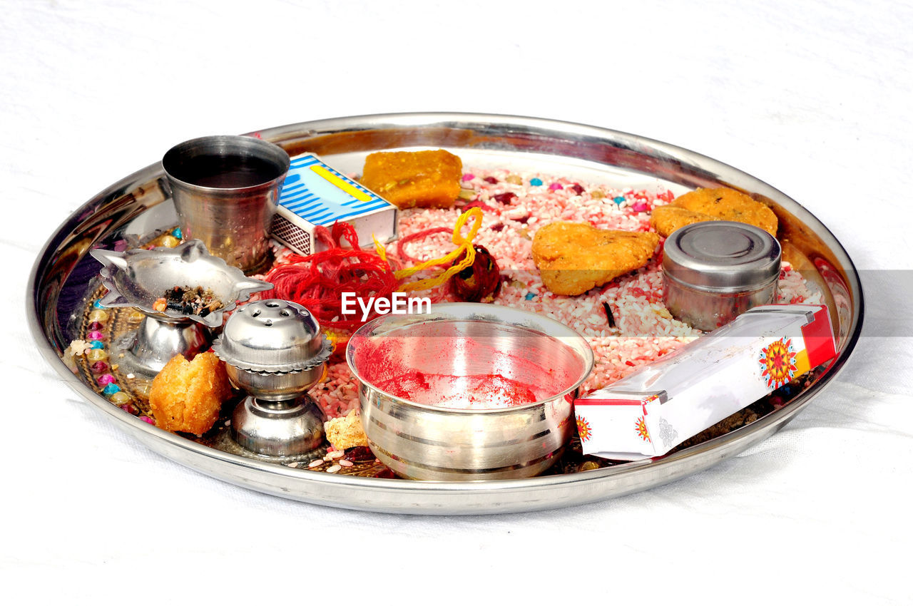 HIGH ANGLE VIEW OF CANDIES ON TABLE AGAINST WHITE BACKGROUND