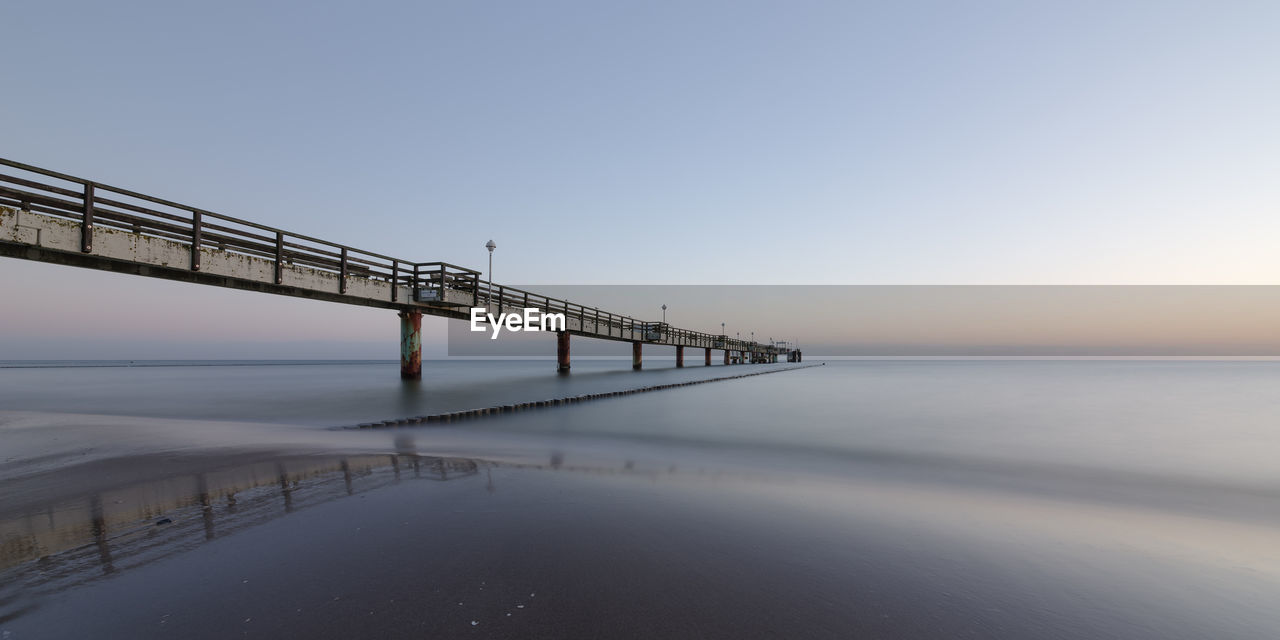 BRIDGE OVER SEA AGAINST CLEAR SKY