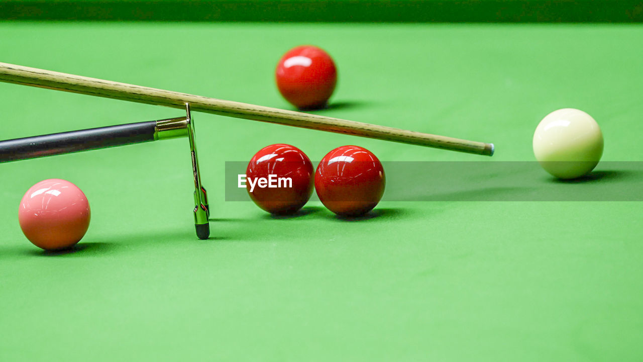 CLOSE-UP OF RED BALL ON TABLE AT HOME