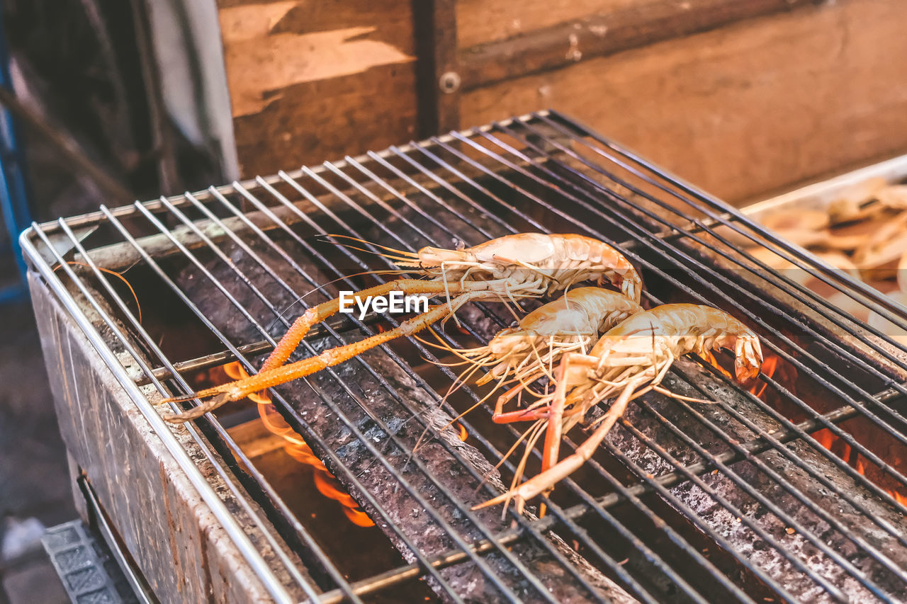 High angle view of meat on barbecue grill