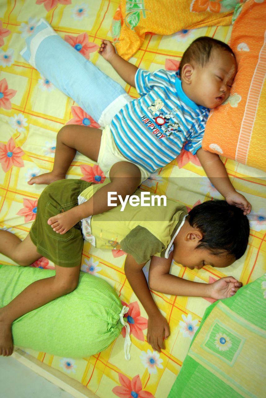 HIGH ANGLE VIEW OF FRIENDS LYING ON FLOOR