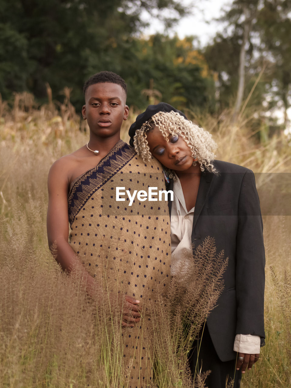 Portrait of smiling couple standing on field
