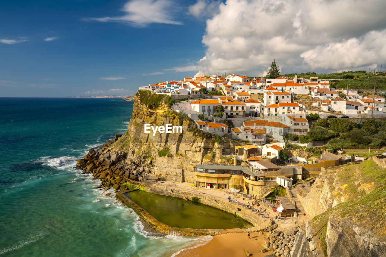 Panoramic view of sea and buildings against sky