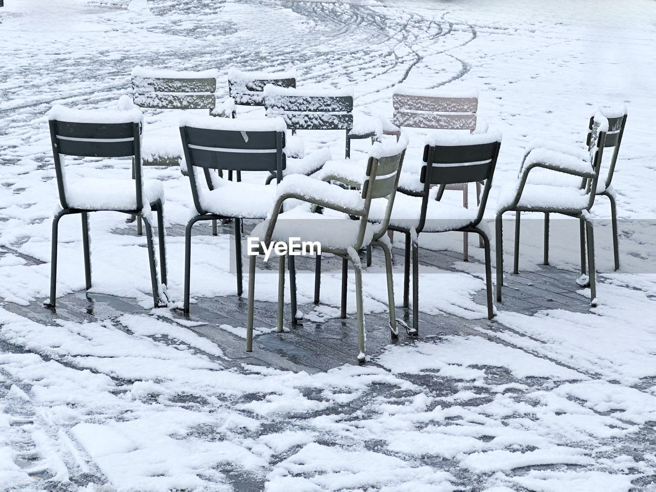 chair, seat, snow, cold temperature, winter, nature, table, no people, land, empty, absence, day, white, beach, scenics - nature, outdoors, beauty in nature, black and white, water, frozen, tranquil scene, tranquility, environment, architecture, in a row