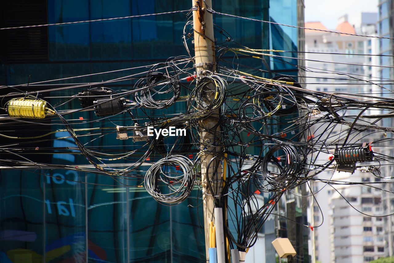 Poles full of telecommunication cables in the city