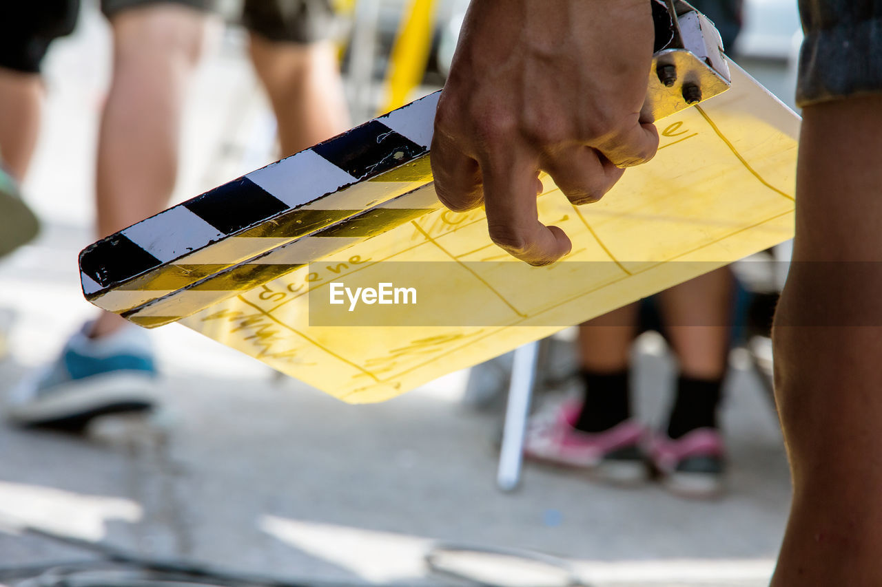 Close up image of film production crew holding film slate on set