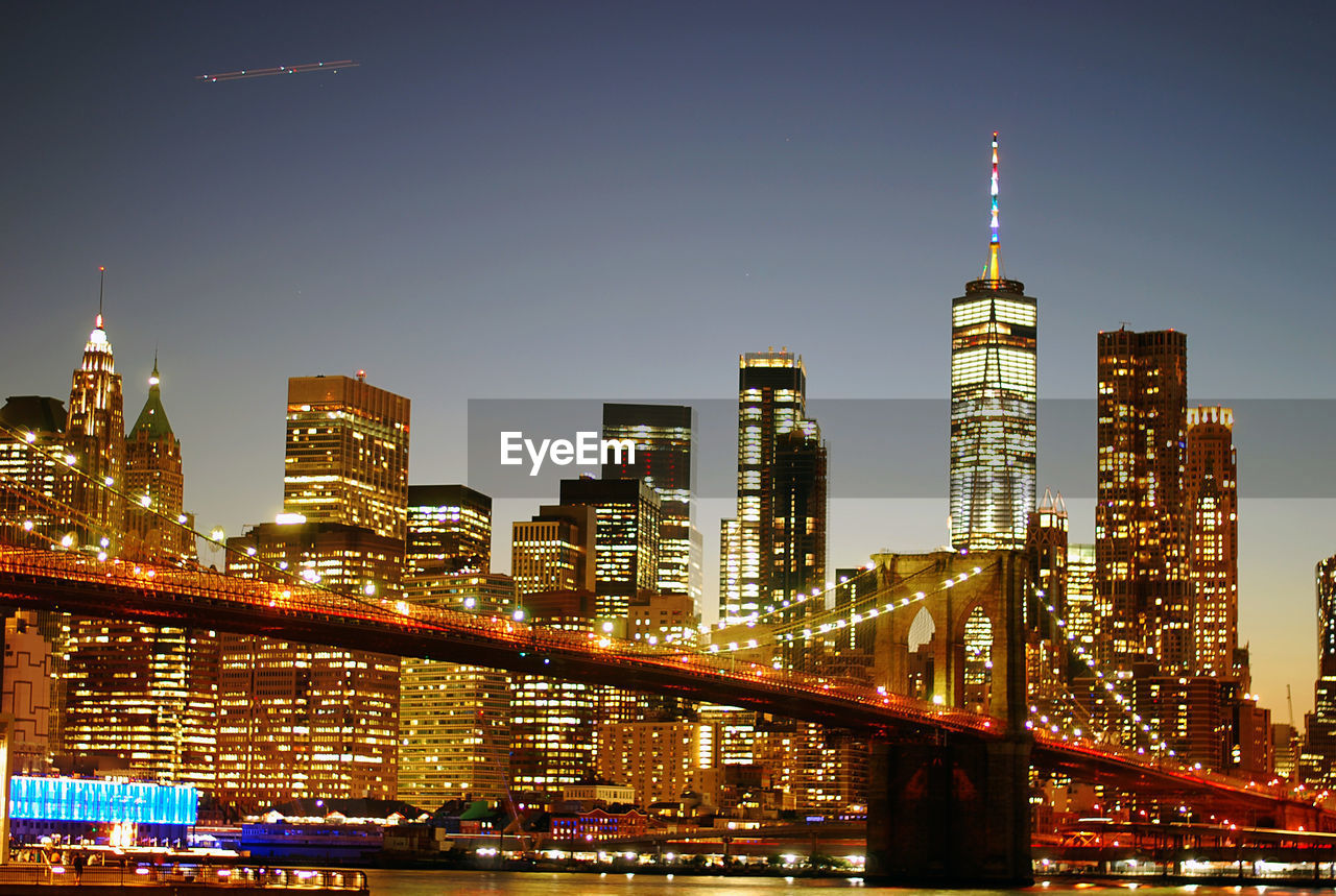 ILLUMINATED BUILDINGS IN CITY AGAINST SKY