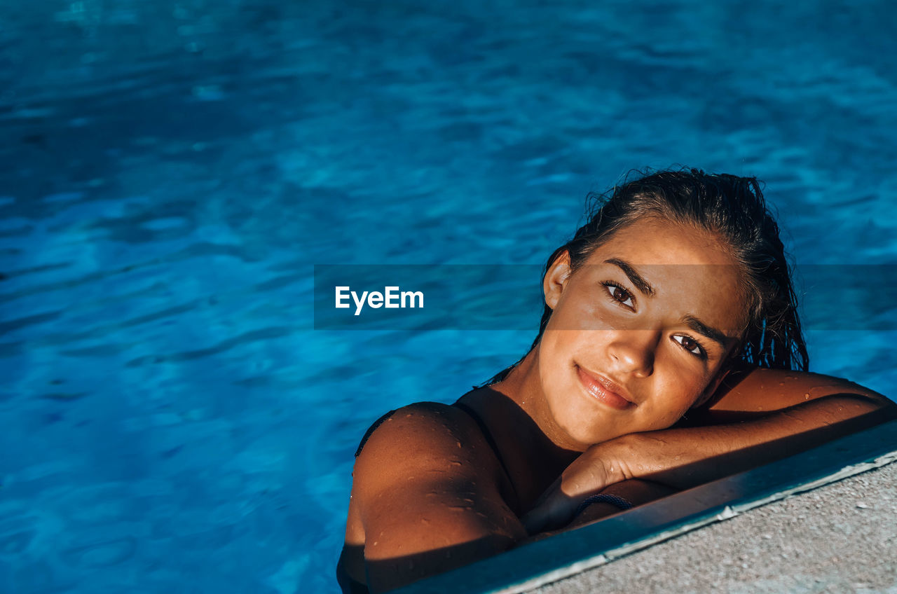 Portrait of young woman in swimming pool