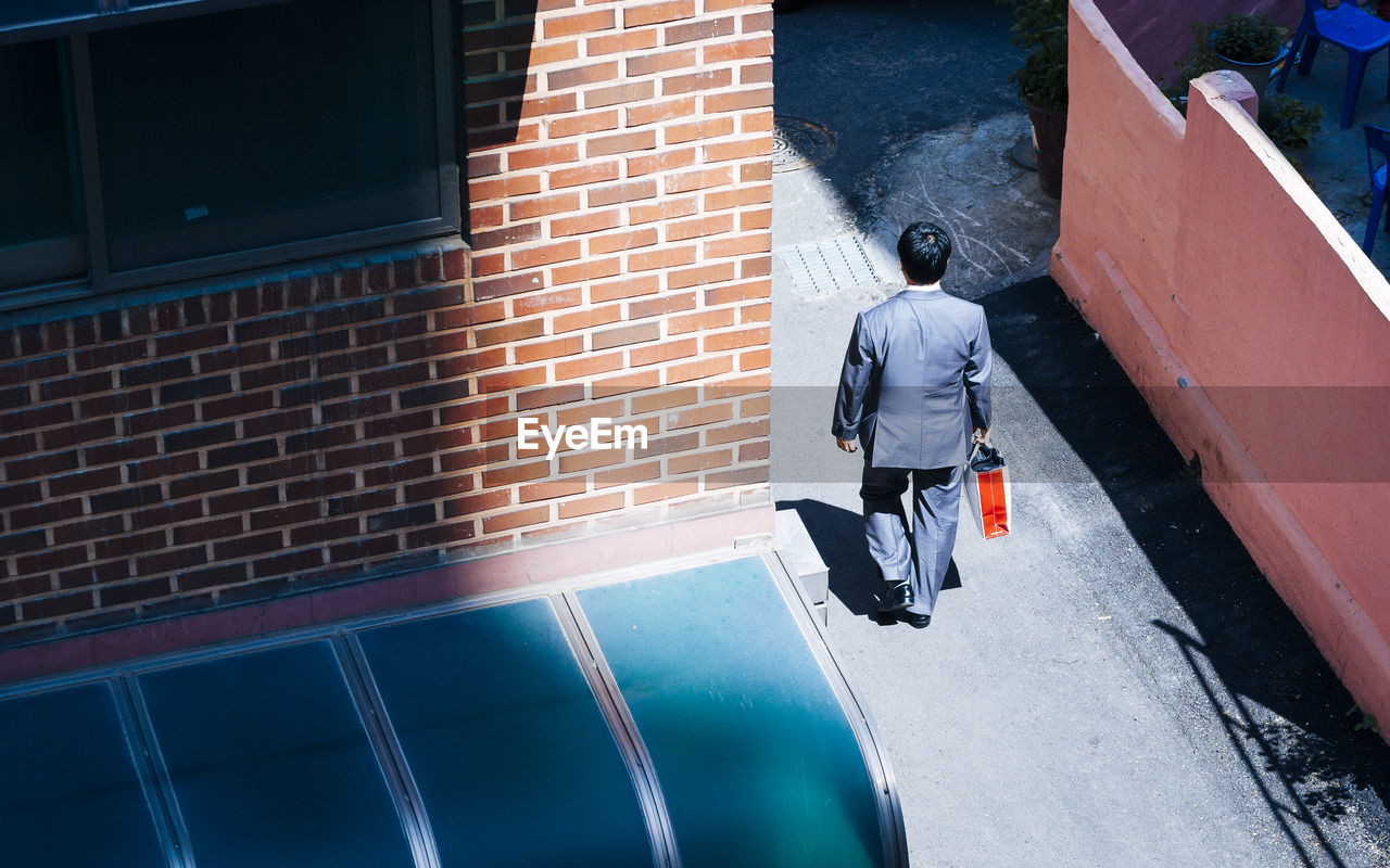 High angle view of businessman walking on street