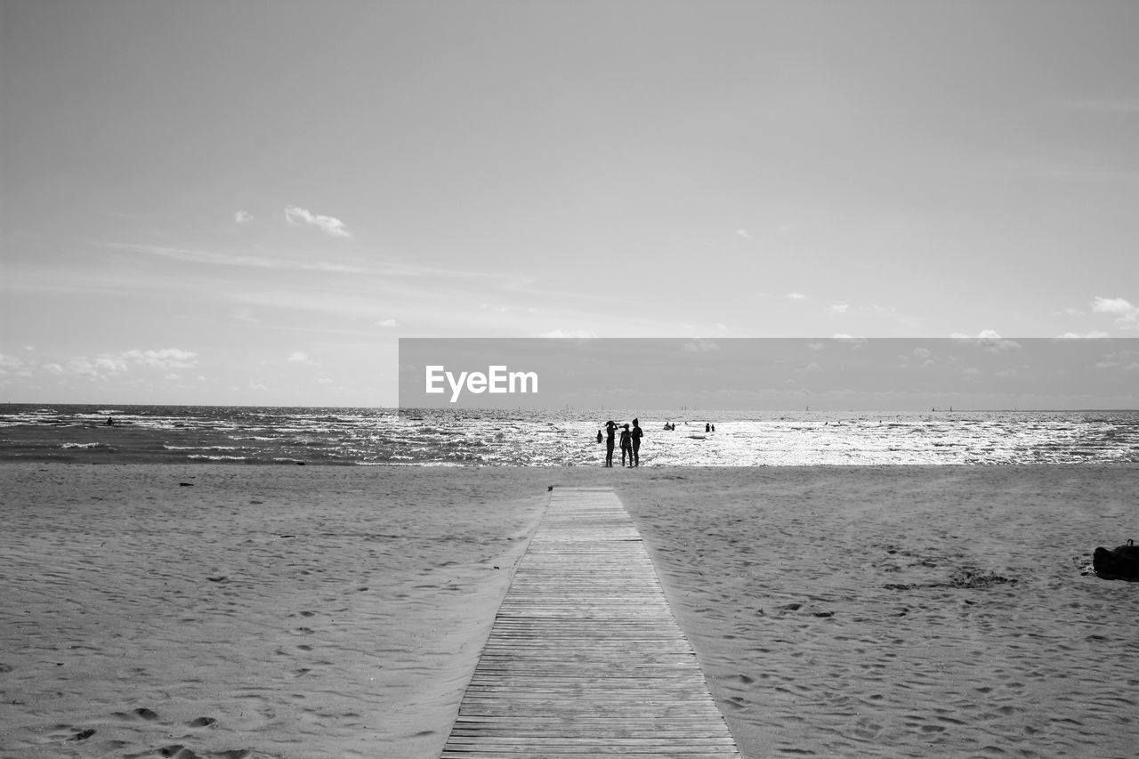 Wooden footpath leading to sea