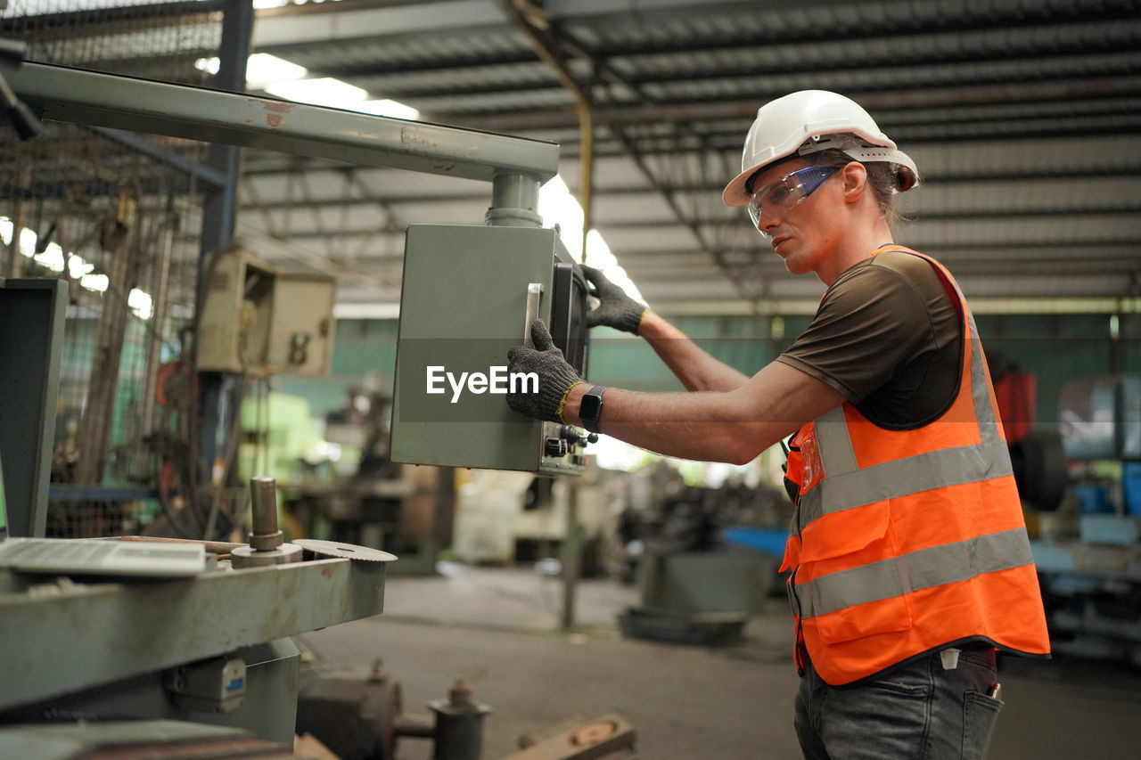 Side view of man working in workshop