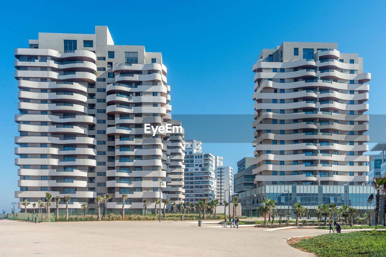 LOW ANGLE VIEW OF BUILDINGS AGAINST CLEAR SKY