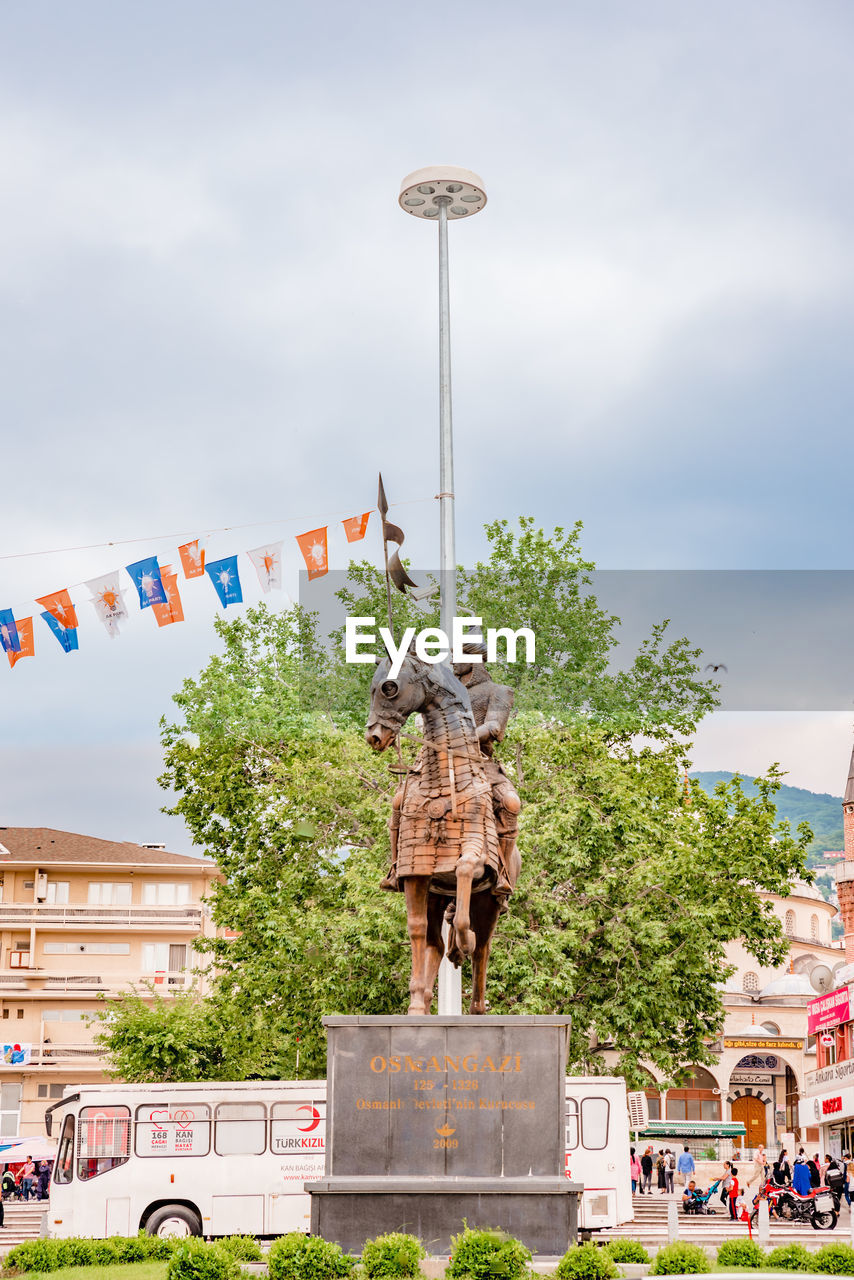 STATUE AGAINST CLEAR SKY